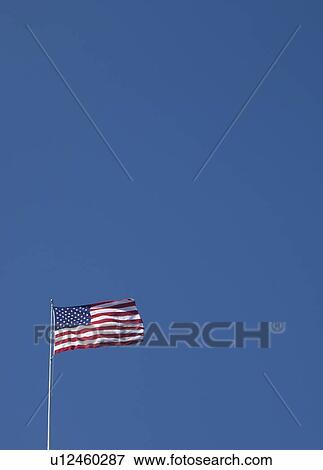 American flag against blue sky View Large Photo Image Stock Photo - American flag against blue sky. Fotosearch