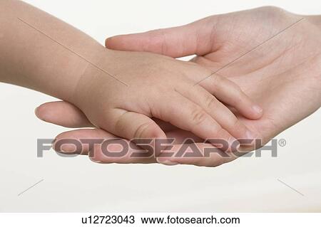 Baby holding hands with mother View Large Photo Image Stock Image - Baby holding hands with mother. Fotosearch