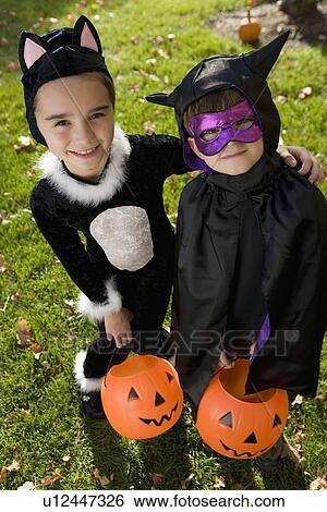 Boy and girl in Halloween costumes View Large Photo Image Stock Photograph - Boy and girl in Halloween costumes. Fotosearch