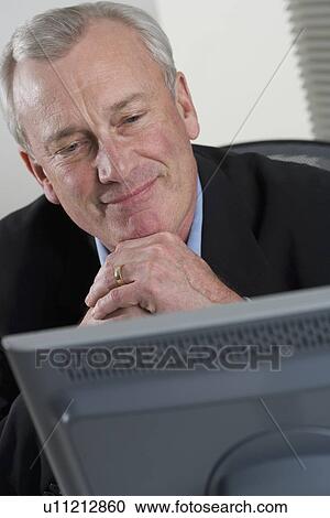 Stock Image - Businessman at work. Fotosearch