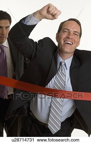 Stock Image - Businessman crossing the finish line. Fotosearch