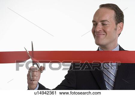 Businessman cutting a ribbon View Large Photo Image Stock Image - Businessman cutting a ribbon. Fotosearch