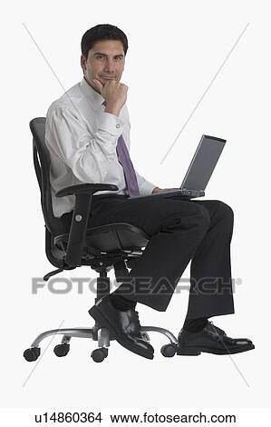 Picture - Businessman holding laptop in chair. Fotosearch