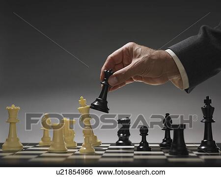 Businessman moving chess piece View Large Photo Image Stock Photograph - Businessman moving chess piece. Fotosearch