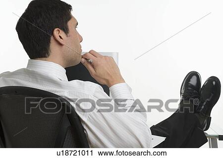 Businessman thinking with feet up View Large Photo Image Stock Image - Businessman thinking with feet up. Fotosearch
