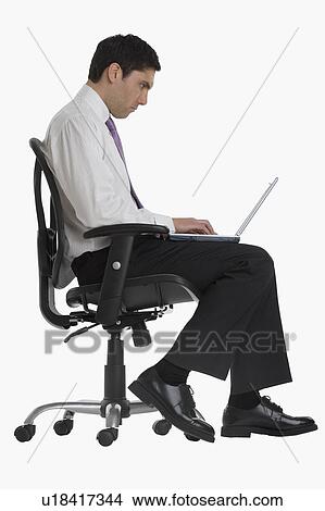 Picture - Businessman typing on laptop. Fotosearch
