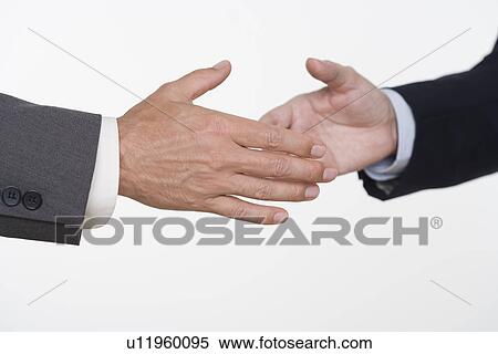 Stock Photography - Businessmen about to shake hands. Fotosearch