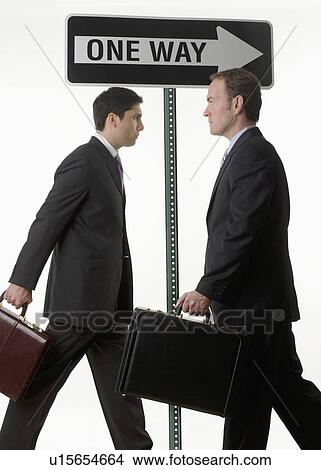Businessmen at one way sign View Large Photo Image Picture - Businessmen at one way sign. Fotosearch
