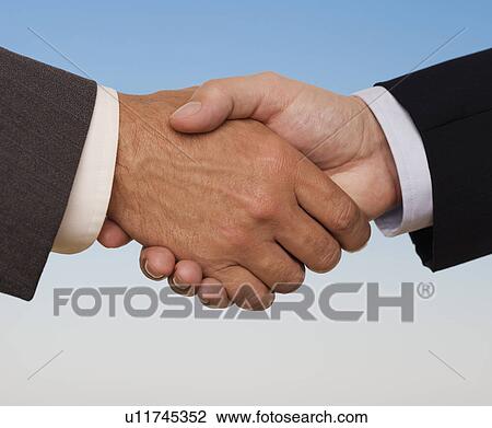 Stock Image - Businessmen shaking hands. Fotosearch