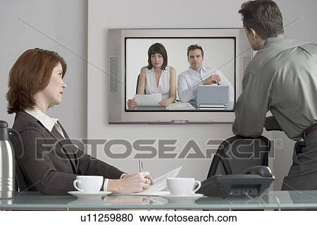 Businesspeople in videoconference View Large Photo Image Stock Image - Businesspeople in videoconference. Fotosearch