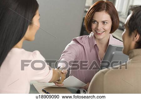 Businesswoman shaking hands in office View Large Photo Image Stock Image - Businesswoman shaking hands in office. Fotosearch