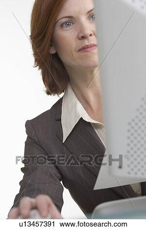 Businesswoman working on computer View Large Photo Image Stock Image - Businesswoman working on computer. Fotosearch