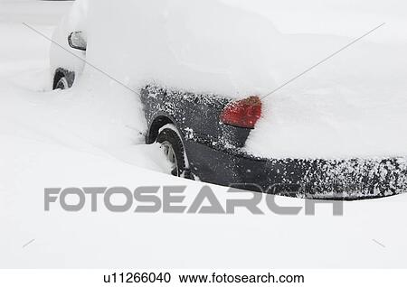 Stock Image - Car buried in snow in winter. Fotosearch