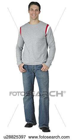 Casual guy with thumbs in his pockets View Large Photo Image Stock Photo - Casual guy with thumbs in his pockets. Fotosearch