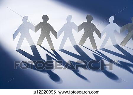 Chain of paperdoll cutouts in spotlight View Large Photo Image Stock Photography - Chain of paperdoll cutouts in spotlight. Fotosearch