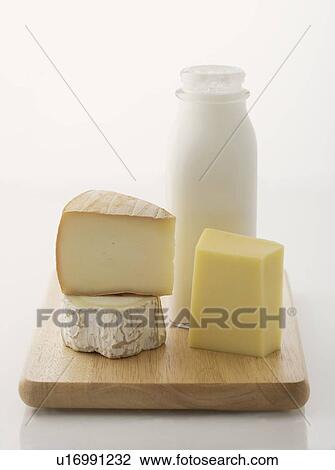 Cheese and milk on cutting board View Large Photo Image Stock Image - Cheese and milk on cutting board. Fotosearch