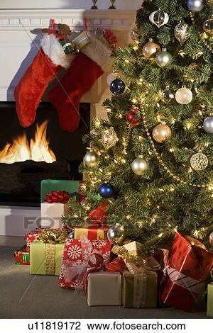 Christmas tree with presents and fireplace with stockings View Large Photo Image Stock Image - Christmas tree with presents and fireplace with stockings. Fotosearch