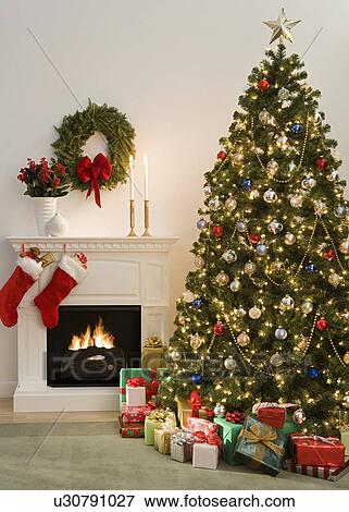 Christmas tree with presents and fireplace with stockings View Large Photo Image Stock Photo - Christmas tree with presents and fireplace with stockings. Fotosearch