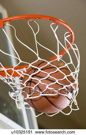 Close up of basketball in hoop View Large Photo Image Stock Image - Close up of basketball in hoop. Fotosearch