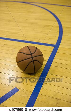 Stock Photo - Close up of basketball on basketball court. Fotosearch