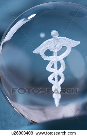 Close up of clear ball with Caduceus symbol in it View Large Photo Image Stock Photo - Close up of clear ball with Caduceus symbol in it. Fotosearch