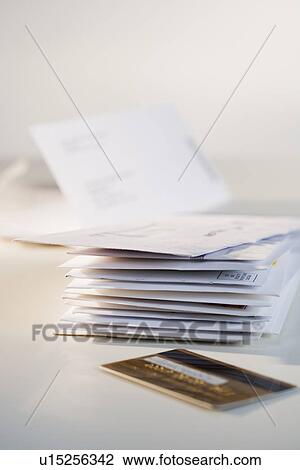 Stock Image - Close up of credit card and mail. Fotosearch