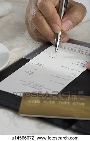 Close up of man signing credit card receipt at restaurant View Large Photo Image Stock Image - Close up of man signing credit card receipt at restaurant. Fotosearch