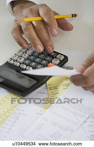 Close up of man using calculator View Large Photo Image Picture - Close up of man using calculator. Fotosearch
