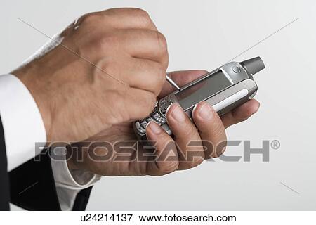 Stock Photo - Close up of man using PDA. Fotosearch
