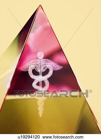 Stock Image - Close up of pyramid with Caduceus symbol in it. Fotosearch