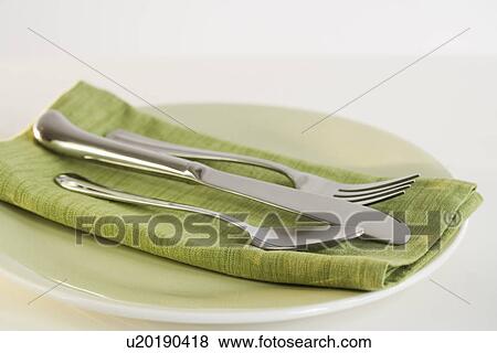 Close up of silverware and napkin on plate View Large Photo Image Stock Photo - Close up of silverware and napkin on plate. Fotosearch
