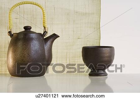 Stock Image - Close up of teapot and cup. Fotosearch
