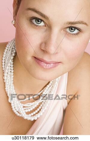 Close up of woman wearing pearls View Large Photo Image Stock Photo - Close up of woman wearing pearls. Fotosearch