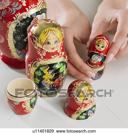 Stock Photo - Close up of woman's hand with nesting dolls. Fotosearch