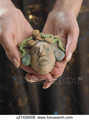 Close up of woman's hands holding clay face View Large Photo Image Stock Photo - Close up of woman's hands holding clay face. Fotosearch