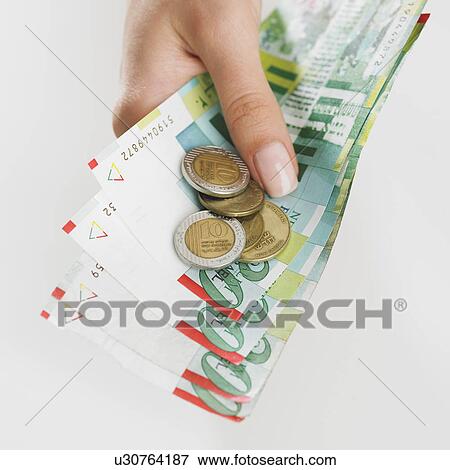 Stock Photo - Close up studio shot of woman's hand holding money. Fotosearch