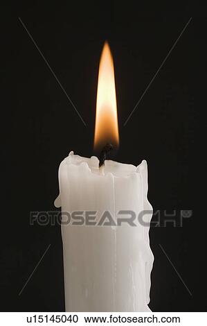 Stock Image - Closeup of a burning candle. Fotosearch