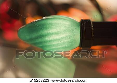 Stock Image - Closeup of a glowing Christmas light bulb. Fotosearch