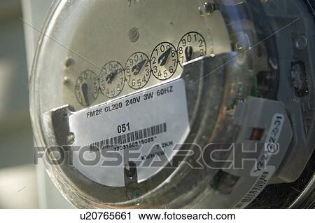 Stock Image - Closeup of a home electric meter. Fotosearch