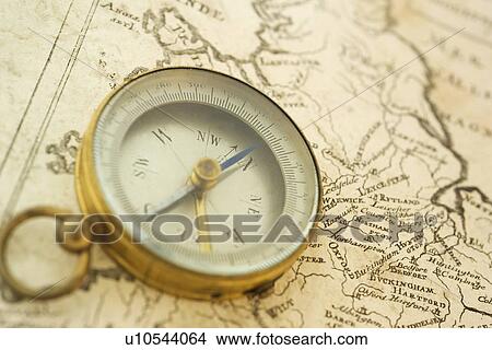 Picture - Closeup of a map and compass. Fotosearch