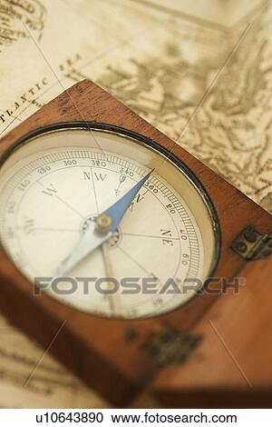 Stock Image - Closeup of a map and compass. Fotosearch