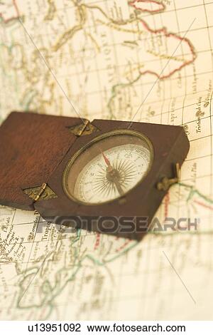 Stock Image - Closeup of a map and compass. Fotosearch