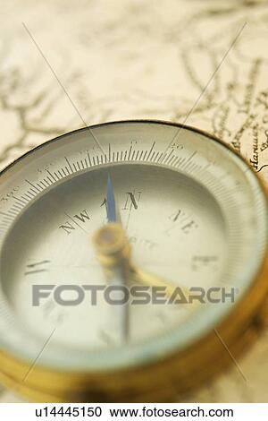 Stock Image - Closeup of a map and compass. Fotosearch