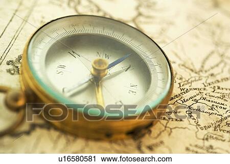 Stock Image - Closeup of a map and compass. Fotosearch