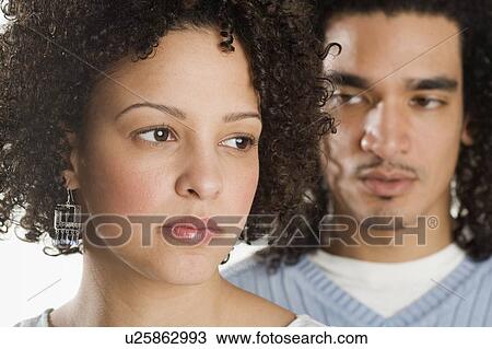 Stock Image - Closeup of a serious couple. Fotosearch