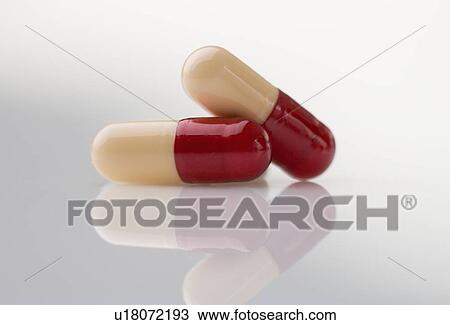 Stock Image - Closeup of capsules with reflection. Fotosearch
