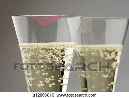 Closeup of champagne with lipstick print View Large Photo Image Stock Photograph - Closeup of champagne with lipstick print. Fotosearch