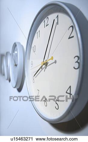 Stock Image - Closeup of clock on wall. Fotosearch