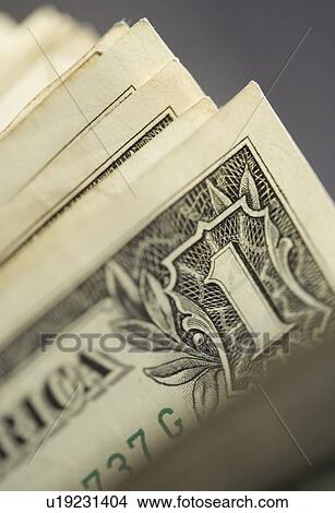 Picture - Closeup of corners of dollar bills. Fotosearch