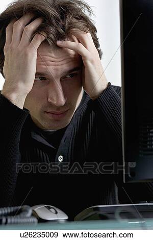 Closeup of distressed man with computer View Large Photo Image Stock Photo - Closeup of distressed man with computer. Fotosearch